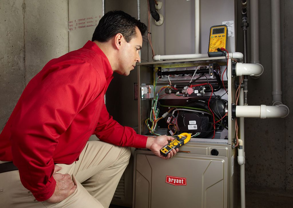 HVAC technician repairing an indoor furnace in Eloy