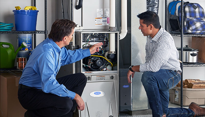 HVAC technician evaluating a furnace for repair or replacement in Eloy