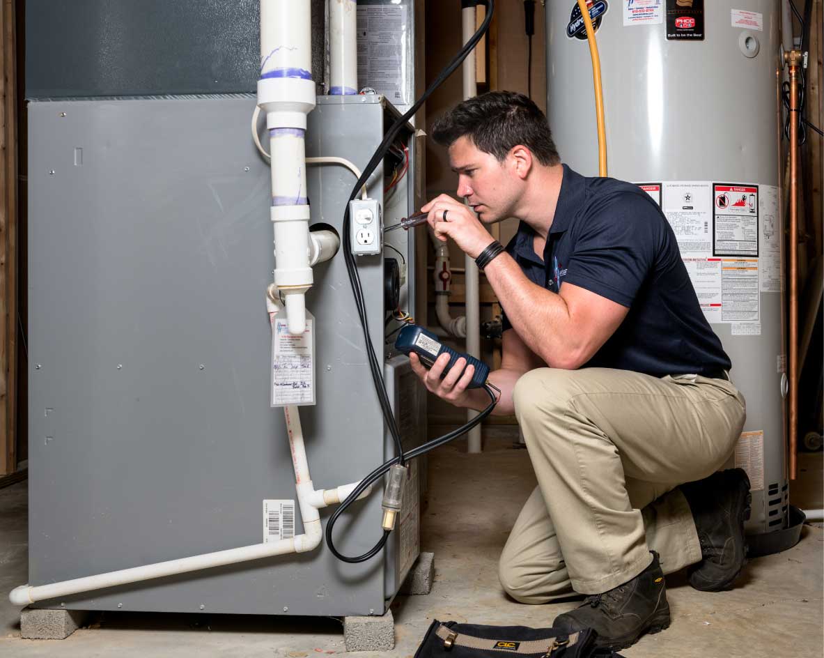 HVAC technician performing a furnace tune-up in Eloy