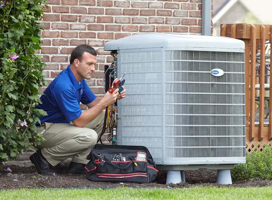 HVAC technician inspecting an outdoor air conditioning unit in Eloy