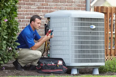 HVAC technician inspecting an outdoor air conditioning unit in Eloy, AZ